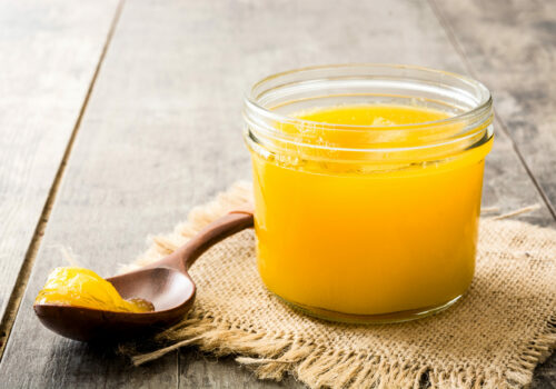 Ghee,Or,Clarified,Butter,In,Jar,And,Wooden,Spoon,On