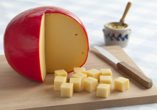 Edam,Cheese,And,Cubes,On,A,Cutting,Board